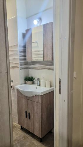 a bathroom with a sink and a mirror at Julieta's house in Chios