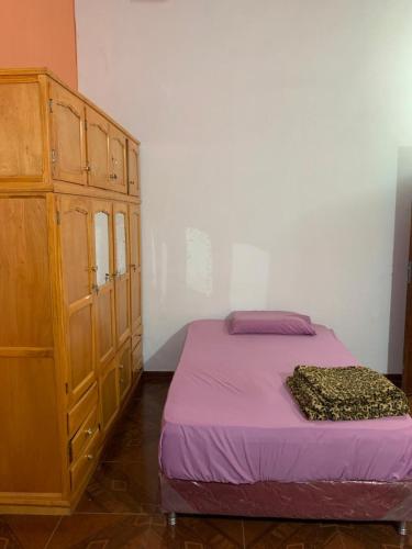 a bedroom with a bed and a wooden cabinet at Habitación 4 in Asunción