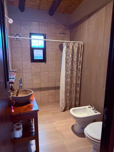 a bathroom with a sink and a toilet and a shower at Barcena Houses in Tumbaya