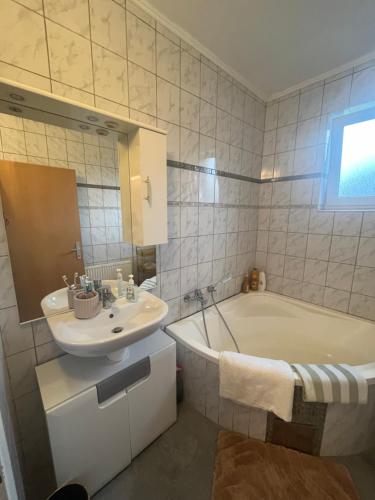 a bathroom with a tub and a sink and a bath tub at Wohnung Sonja in Villach