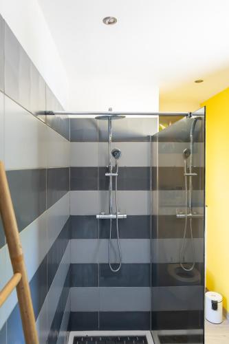 a bathroom with a shower with a glass door at Villa Coeur Bleu in Petit-Bourg