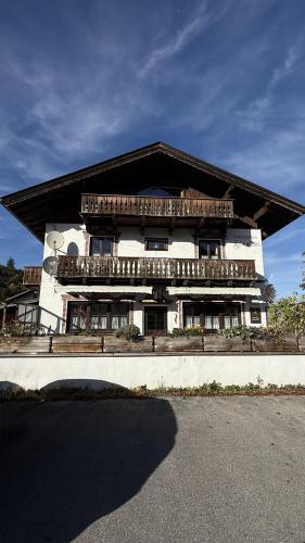 a large white building with balconies on top of it at Gasthof Königstand in Garmisch-Partenkirchen