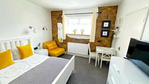 a bedroom with a bed and a dining room at Trinity House London Walthamstow in London