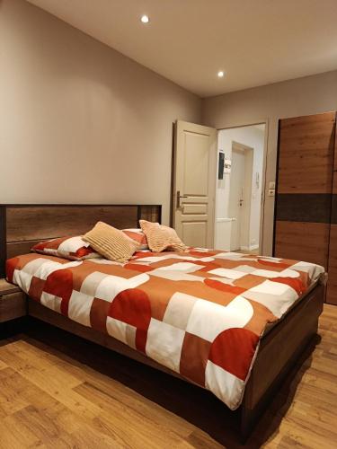 a bedroom with a large bed with a striped comforter at Appartement 2 in Aubigny-sur-Nère
