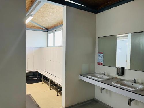 a bathroom with two sinks and a mirror at Deolinda Charming Boat Stay at Oriente Marina in Lisbon