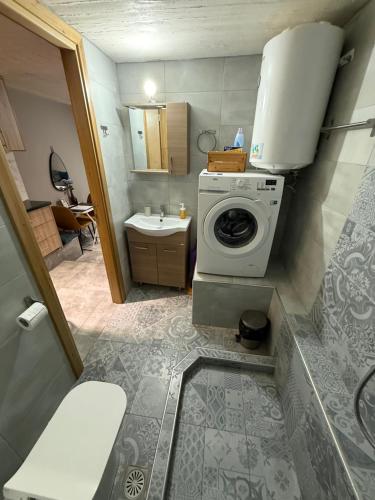 a bathroom with a washing machine and a sink at JTverga SEA VIEW HOMES A2 with Parking in Kalamata