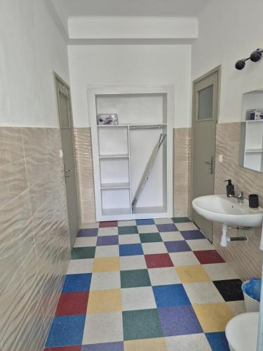 a bathroom with a colorful checkered floor at appartement Rabat Gare à 3min,Rabat honey house in Rabat