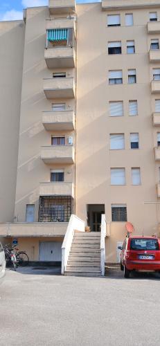 a building with a red car parked in front of it at ROSA BLU House Ospedale Cisanello Pisa in Pisa