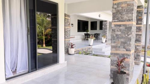 a house with a large glass door with a patio at The Hill Manor in Ndola