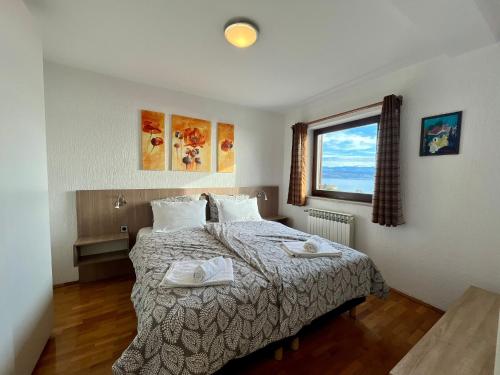a bedroom with a bed with two towels on it at Villa Kubo in Lovran