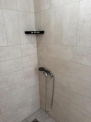 a shower with a shower head in a bathroom at Apartments Sole 2 in Sutomore