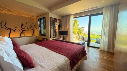 a bedroom with a large bed and a large window at Quinta Vale da Roca in Sintra