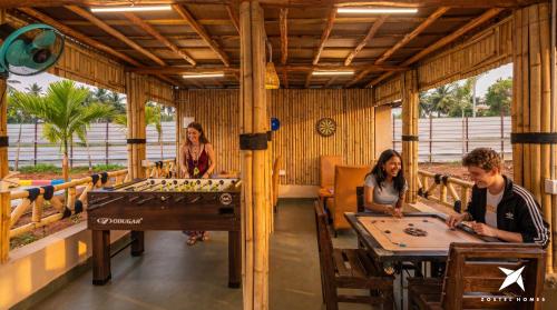 a group of people playing a game of foosball at Zostel Homes Hampi in Hampi