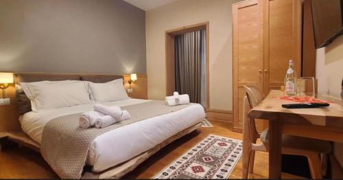 a hotel room with a bed with towels on it at Hotel Velar in Korçë