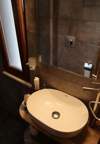 a bathroom with a white sink and a mirror at Hotel Velar in Korçë