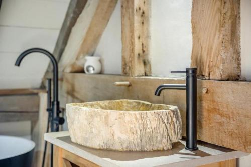 a sink with a wooden bowl on a counter at Unique Luxury Barn in Tenbury