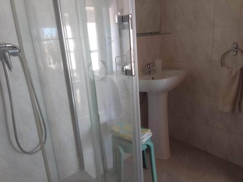 a bathroom with a shower and a sink at Alojamento Mareta in Sagres