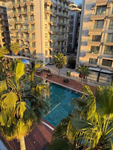 an overhead view of a pool with palm trees and buildings at Apartment Gerti - Sea view in Shëngjin
