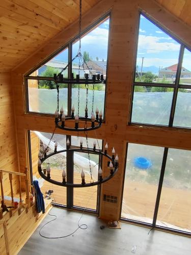 a chandelier hanging from the ceiling of a cabin at Zhyrgallaif in Darkan