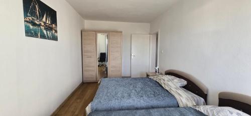 a bedroom with a bed in a white room at Boka Bay in Tivat