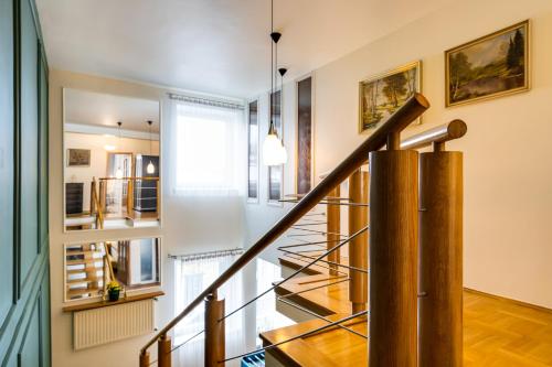 a staircase in a home with white walls and wood floors at Apartamenty Centrum 50 m od Rynku, FREE PARKING in Nowy Targ