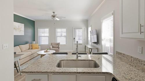 a kitchen with a sink and a living room at Landing Beautiful 1BD Clubhouse Pool in Owens Cross Roads