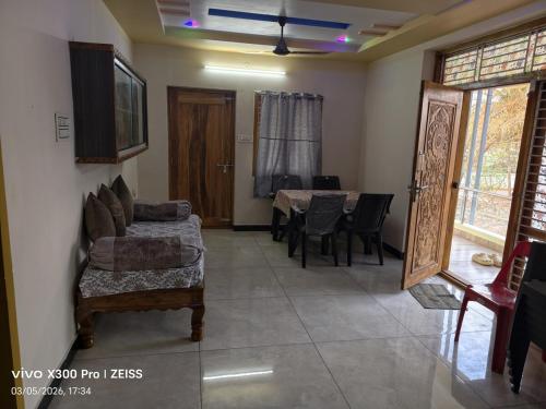 a living room with a table and a dining room at Dev Homestay kakinada in Kākināda