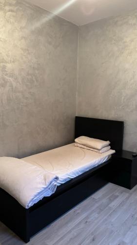 a bedroom with a bed with a black headboard at Andalous in Aït Ali