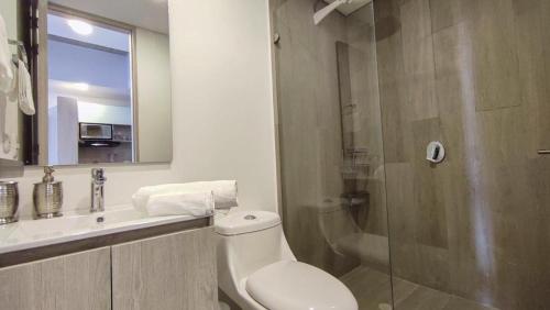 a bathroom with a toilet and a sink and a shower at Confortable Apartamento Centro de Bogotá in Bogotá