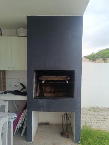 a blue fireplace with a stove in a kitchen at Casa próxima a orla in Pelotas