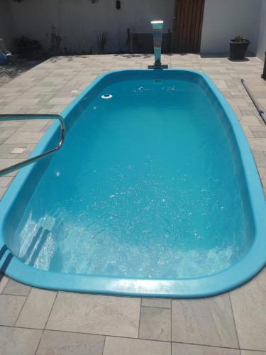 a large blue hot tub sitting on a patio at Casa próxima a orla in Pelotas
