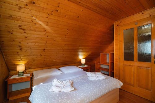 a bedroom with a bed with towels on it at Chata Zuzana in Terchová