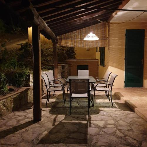 a patio with a table and chairs under a pergola at Blue Living - Alta Marina in Marciana Marina