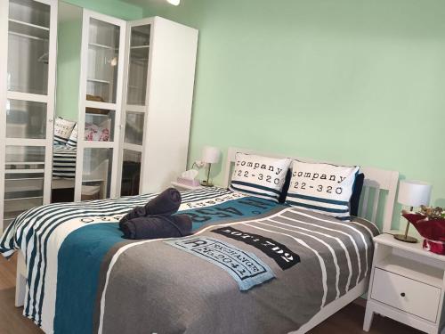 a bedroom with a bed with a teddy bear on it at Imperial Rabat - MAKE IT YOURS in Rabat