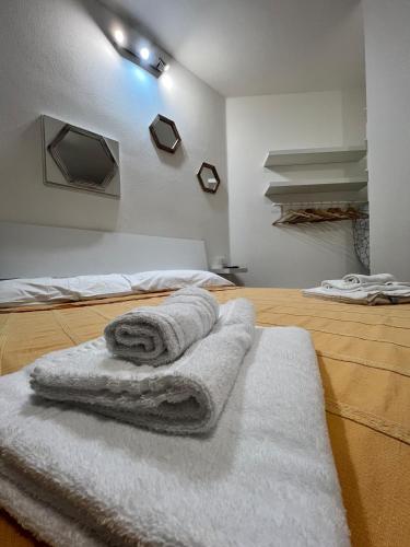 a room with two beds with towels on the floor at Casa Anna in Costa Rei