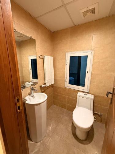 a bathroom with a toilet and a sink at Dreamland royal suite in Rawalpindi