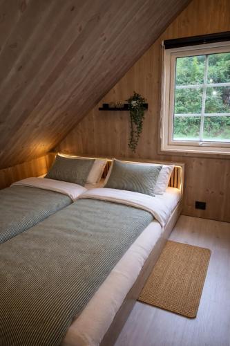 a large bed in a room with a window at Stunning 3-Bedroom Apartment at Feda Waterfront in Feda