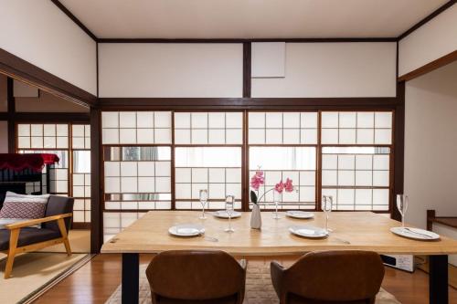 a dining room with a wooden table and chairs at Irest village Ashikaga in Ashikaga