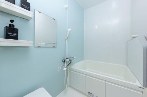 a bathroom with a shower with a glass door at Irest village Ashikaga in Ashikaga