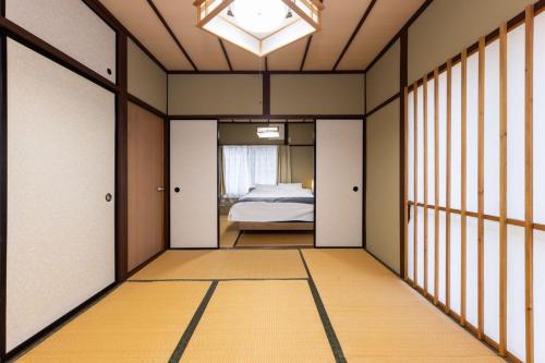 a hallway with a room with a bed and a window at Irest village Ashikaga in Ashikaga