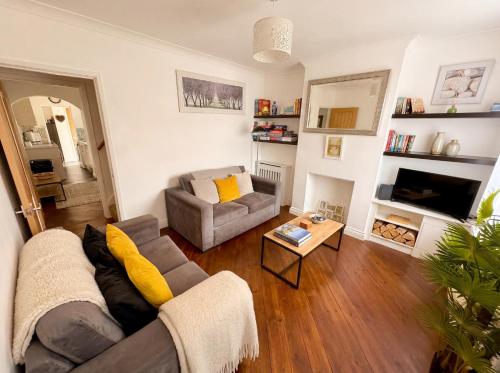 a living room with a couch and a table at Bright 3 bedroom townhouse near city centre in Norwich