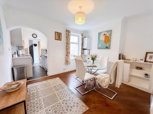 a kitchen and living room with a table and chairs at Bright 3 bedroom townhouse near city centre in Norwich