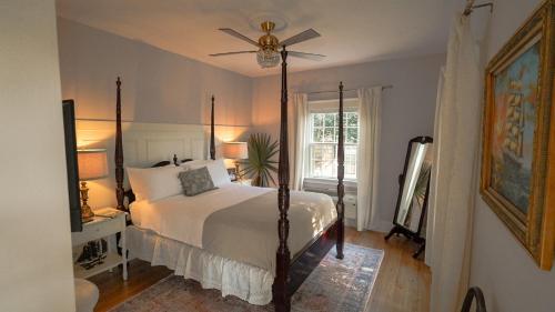 a bedroom with a bed and a ceiling fan at Thurston House Inn in Ocracoke