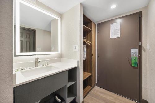 a bathroom with a sink and a mirror at La Quinta by Wyndham Nashville Airport/Opryland in Nashville