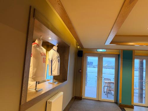 a room with two mannequins in front of a door at Riverside Haven in Crowle