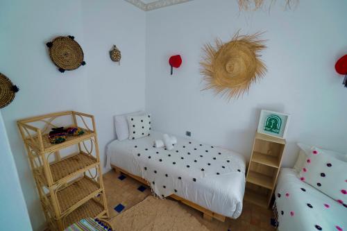 a small bedroom with a bed and a shelf at CASA ADiL in Tangier