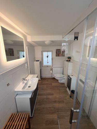 a bathroom with two sinks and a toilet at Wohlfühlbude Fehmarn in Fehmarn