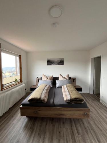 a bedroom with a large bed in a room at Wunderschönes Haus am Waldrand für max 8 Personen in Harztor