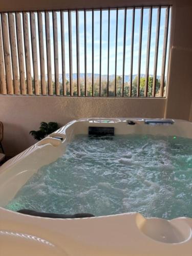 a jacuzzi tub in a room with a window at Hot Room Sainte Victoire in Trets