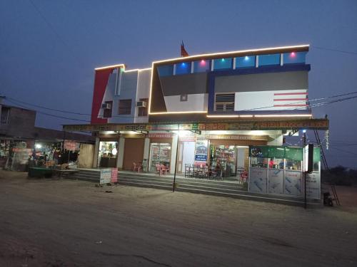a gas station with an american flag on it at Hotel Swami in Gogameri
